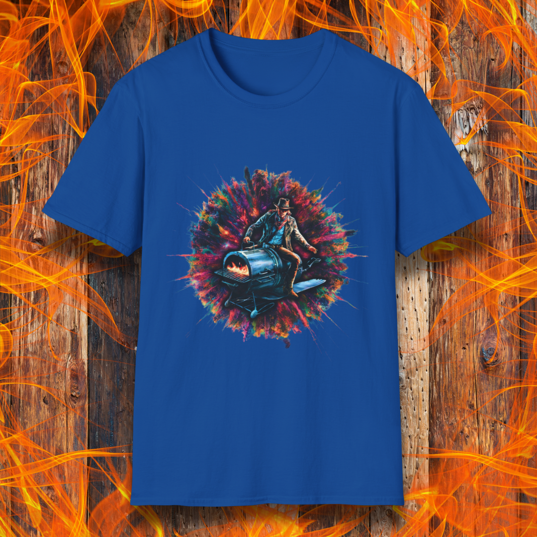 Royal Blue T-shirt featuring a striking design of a cowboy riding a futuristic, rocket-powered barbecue smoker. The artwork is set against an explosive, colorful cosmic backdrop, blending elements of Western and sci-fi themes for a bold grilling statement.