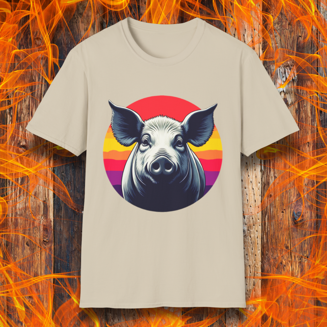 Sand T-shirt featuring a striking illustration of a pig's face in a bold, high-contrast style, set against a circular sunset background with vibrant red, orange, and purple hues. The design gives a rustic yet modern feel, making it an excellent choice for BBQ lovers.