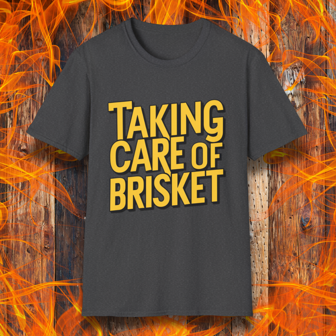 Dark Heather T-shirt with bold yellow text reading 'Taking Care of Brisket,' a fun BBQ-themed design inspired by classic rock and grilling culture.
