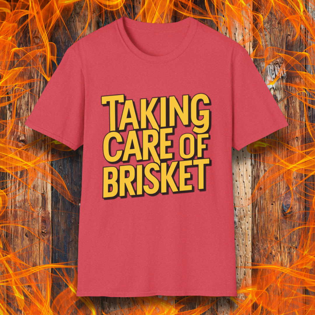 Heather Red T-shirt with bold yellow text reading 'Taking Care of Brisket,' a fun BBQ-themed design inspired by classic rock and grilling culture.