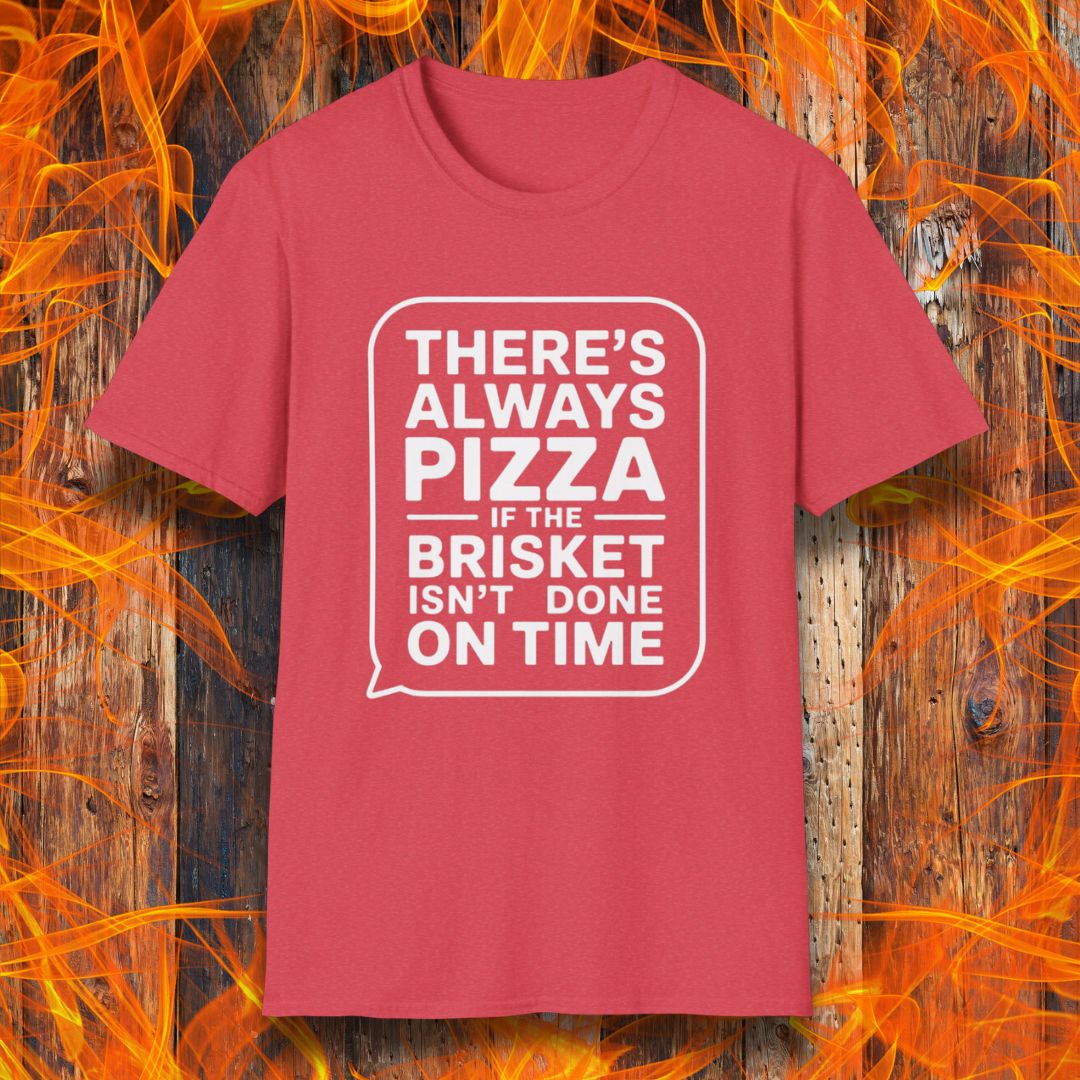 Heather Red T-shirt featuring bold white text in a speech bubble that reads "There’s Always Pizza If the Brisket Isn’t Done on Time," displayed over a wooden background with flames — a humorous shirt for BBQ fans who know the struggle of low-and-slow cooking.