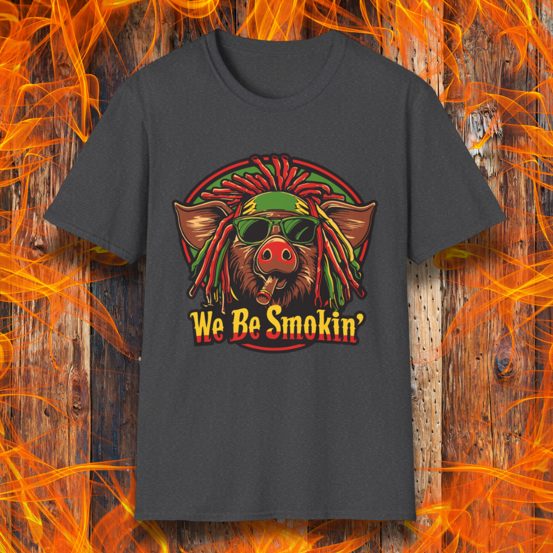 Dark Heather T-shirt featuring a cool, reggae-inspired pig with dreadlocks, sunglasses, and a cigar, with the phrase 'We Be Smokin’' in bold, fiery lettering. A must-have for BBQ lovers who like to keep it chill while grilling!