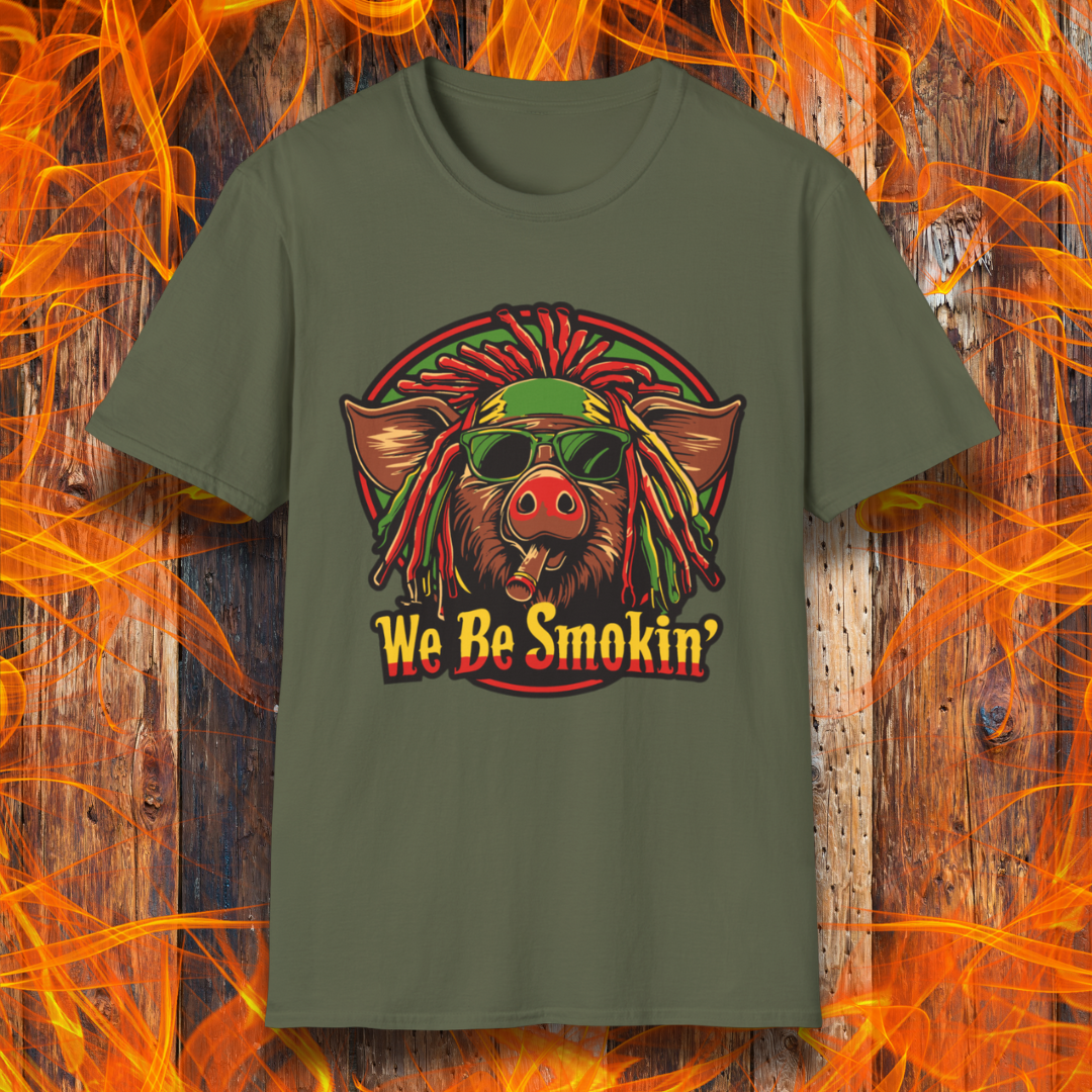 Military Green T-shirt featuring a cool, reggae-inspired pig with dreadlocks, sunglasses, and a cigar, with the phrase 'We Be Smokin’' in bold, fiery lettering. A must-have for BBQ lovers who like to keep it chill while grilling!