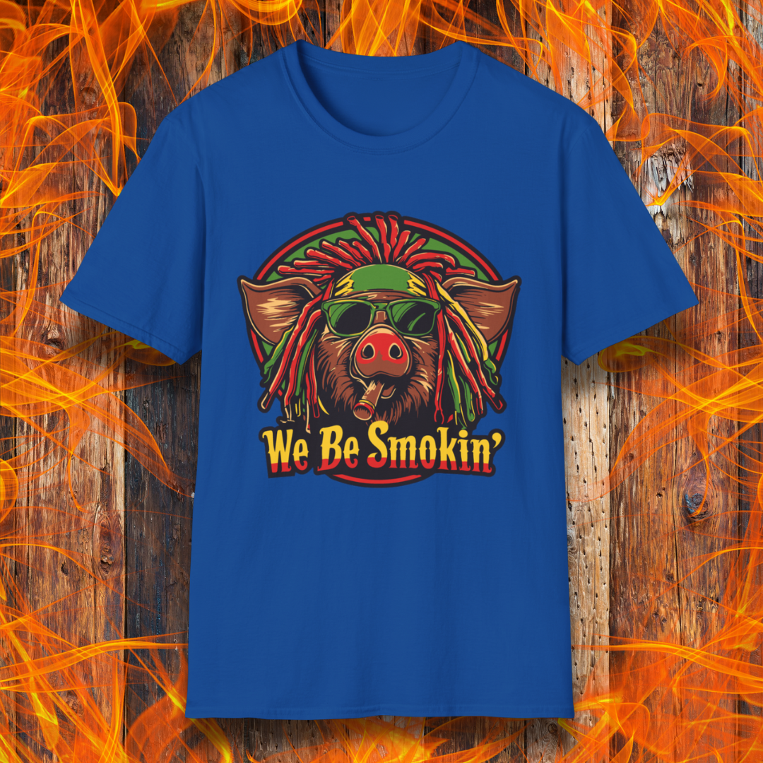 Royal Blue T-shirt featuring a cool, reggae-inspired pig with dreadlocks, sunglasses, and a cigar, with the phrase 'We Be Smokin’' in bold, fiery lettering. A must-have for BBQ lovers who like to keep it chill while grilling!