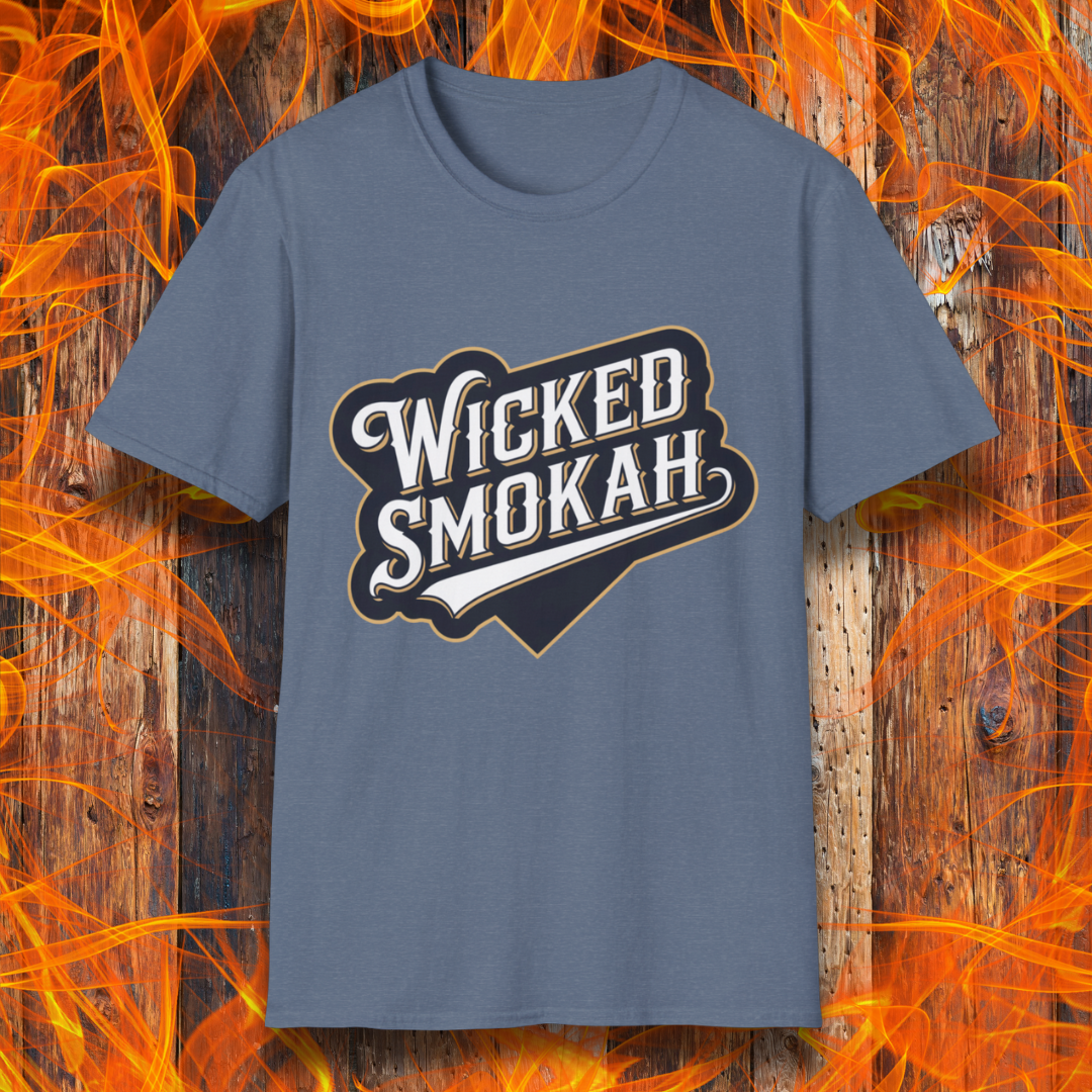 Heather Indigo T-shirt featuring a bold, vintage-style design that reads "Wicked Smokah" in stylized typography, resembling a sports team logo. The lettering has a mix of white and gold outlines, giving it a classic and rugged look. The shirt is displayed against a fiery wooden background, reinforcing the smoky BBQ theme.