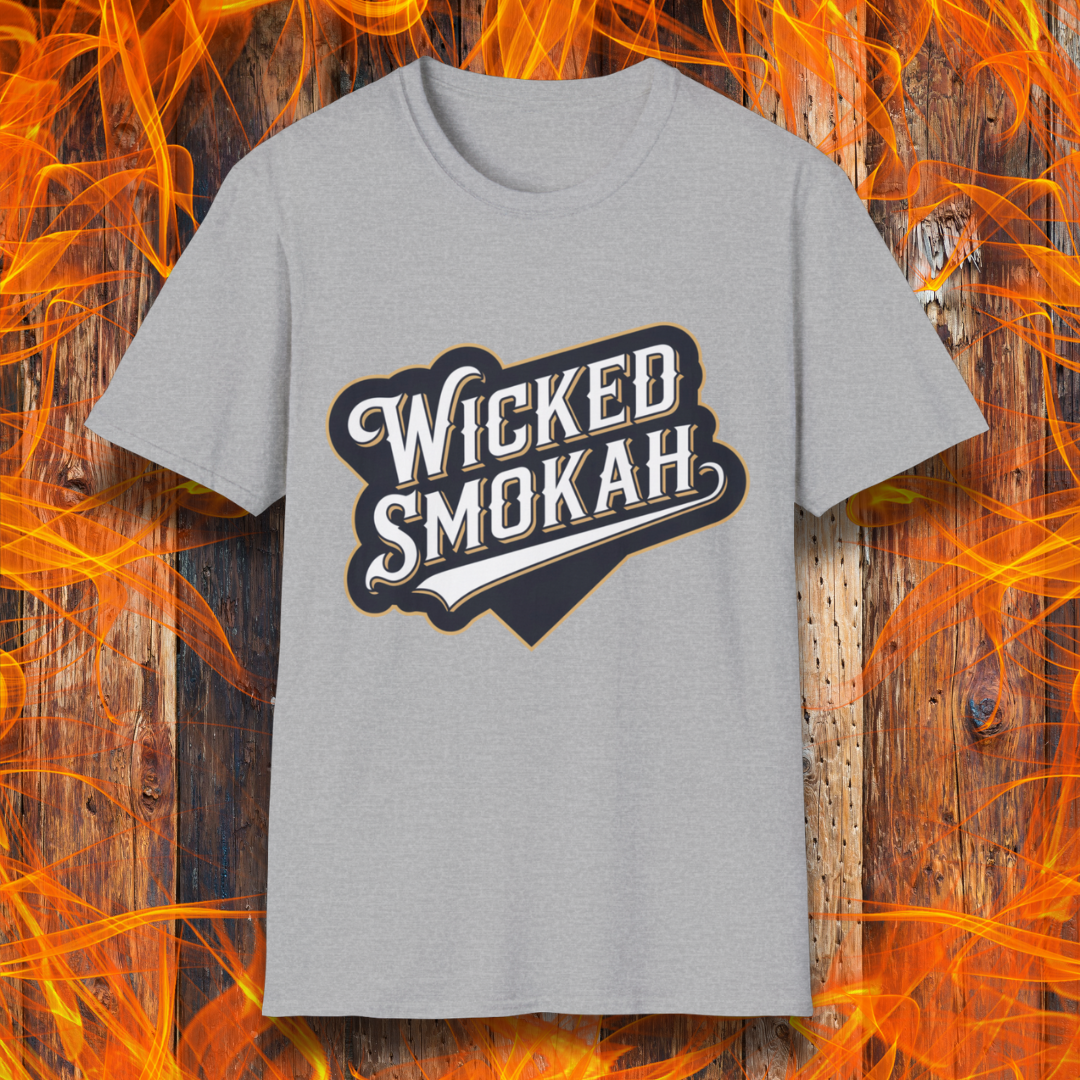 Sport Grey T-shirt featuring a bold, vintage-style design that reads "Wicked Smokah" in stylized typography, resembling a sports team logo. The lettering has a mix of white and gold outlines, giving it a classic and rugged look. The shirt is displayed against a fiery wooden background, reinforcing the smoky BBQ theme.