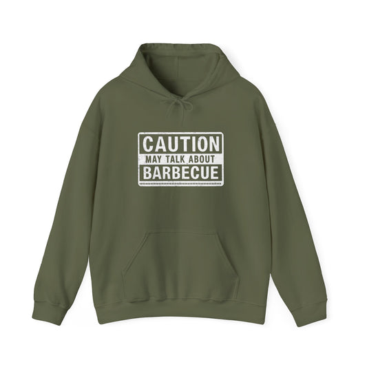 Green hoodie with 'Caution: May Talk About Barbecue' text on a white background