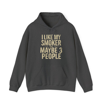 Dark gray hoodie with gold text I Like My Smoker and Maybe 3 People” on a white background
