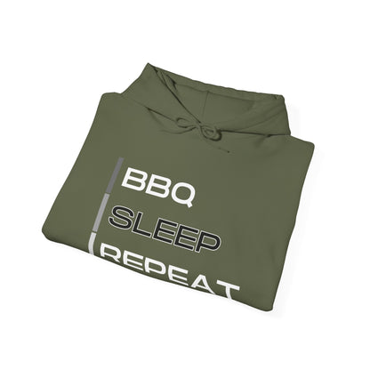 Folded green hoodie with 'BBQ SLEEP REPEAT' text on a white background