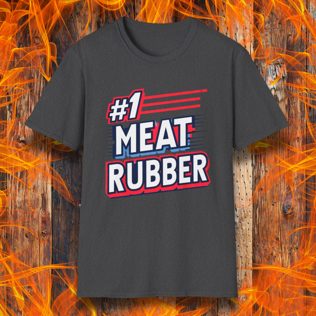 Dark Heather T-shirt featuring a bold and humorous BBQ-themed design that reads '#1 MEAT RUBBER' in white and navy block lettering with red and blue speed-line accents. Perfect for grill masters and barbecue lovers with a sense of humor.