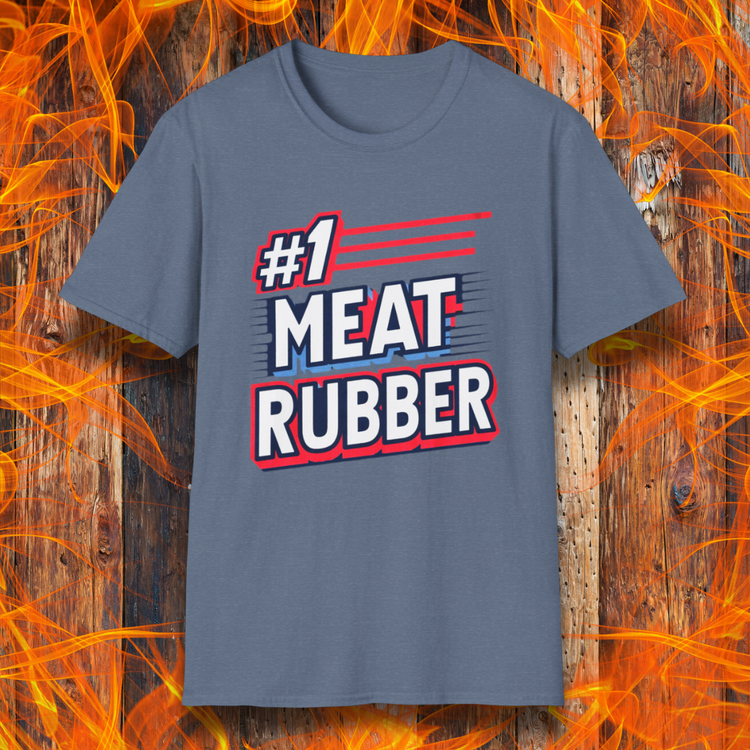 Heather Indigo T-shirt featuring a bold and humorous BBQ-themed design that reads '#1 MEAT RUBBER' in white and navy block lettering with red and blue speed-line accents. Perfect for grill masters and barbecue lovers with a sense of humor.
