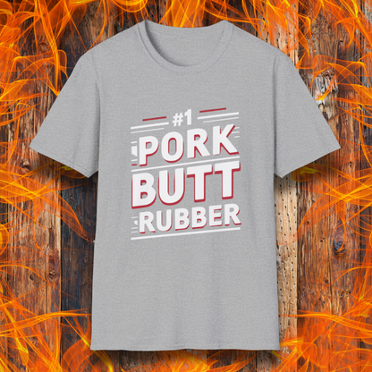 Sport Grey T-shirt featuring a bold, humorous BBQ-themed design that reads '#1 PORK BUTT RUBBER' in red and white block lettering with stylish line accents. A fun shirt for grill masters and barbecue enthusiasts.