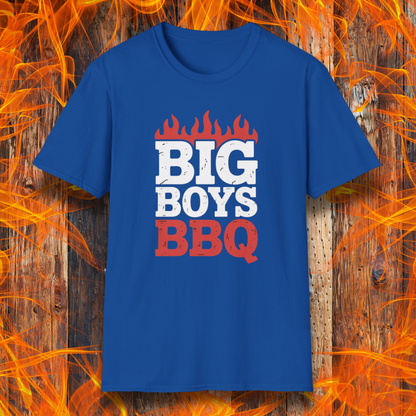 Blue t-shirt with 'BIG BOYS BBQ' text on a wooden background with flames.