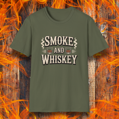 Green t-shirt with 'Smoke and Whiskey' text on a wooden background with flames.