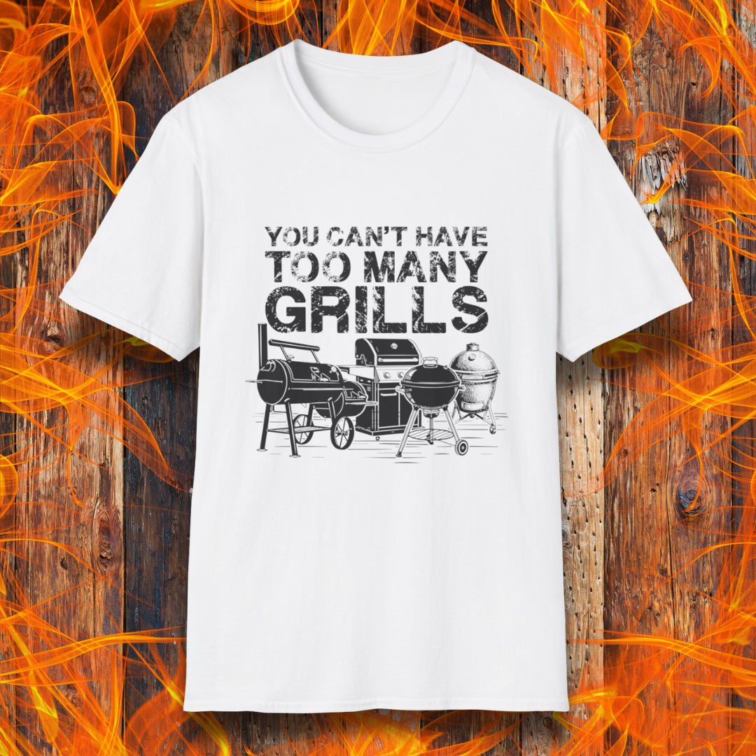 White t-shirt with 'You can't have too many grills' graphic on a wooden background with grill images.
