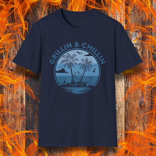 Navy blue t-shirt with 'Grillin & Chillin' graphic on a wooden background with flames.