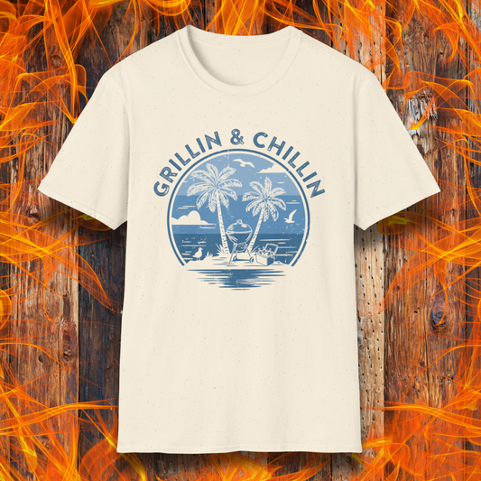 Beige t-shirt with 'Grillin & Chillin' design on a wooden background with flames.