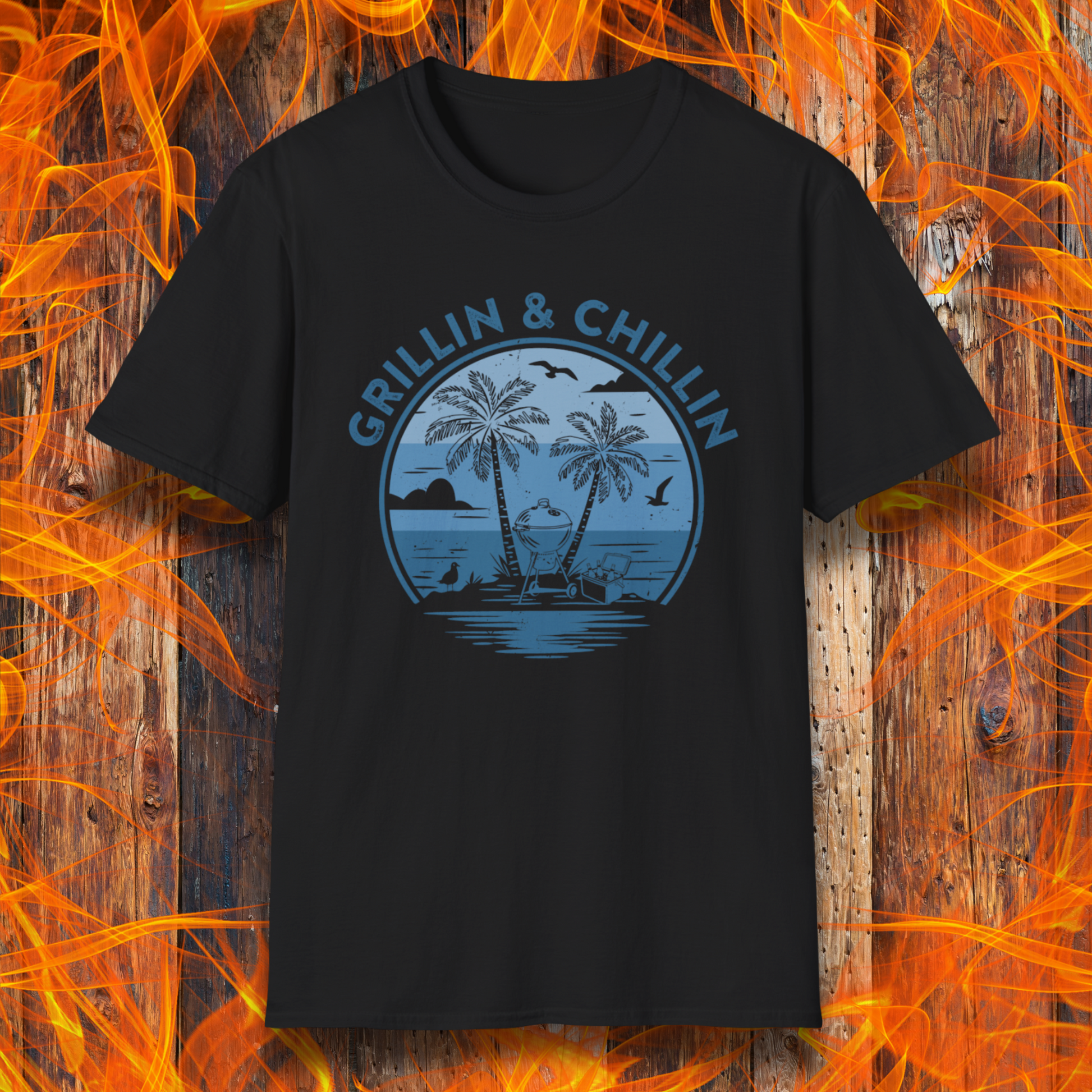 Black t-shirt with 'Grillin & Chillin' graphic design on a wooden background with flames.