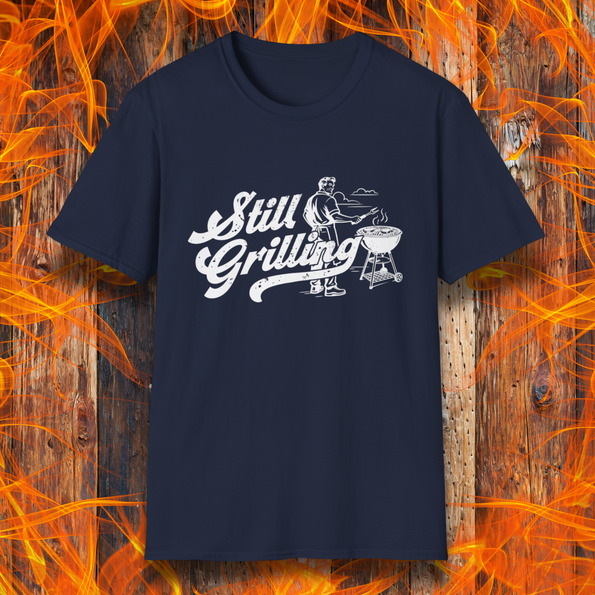 Navy blue t-shirt with 'Still Grilling' graphic on a fiery background
