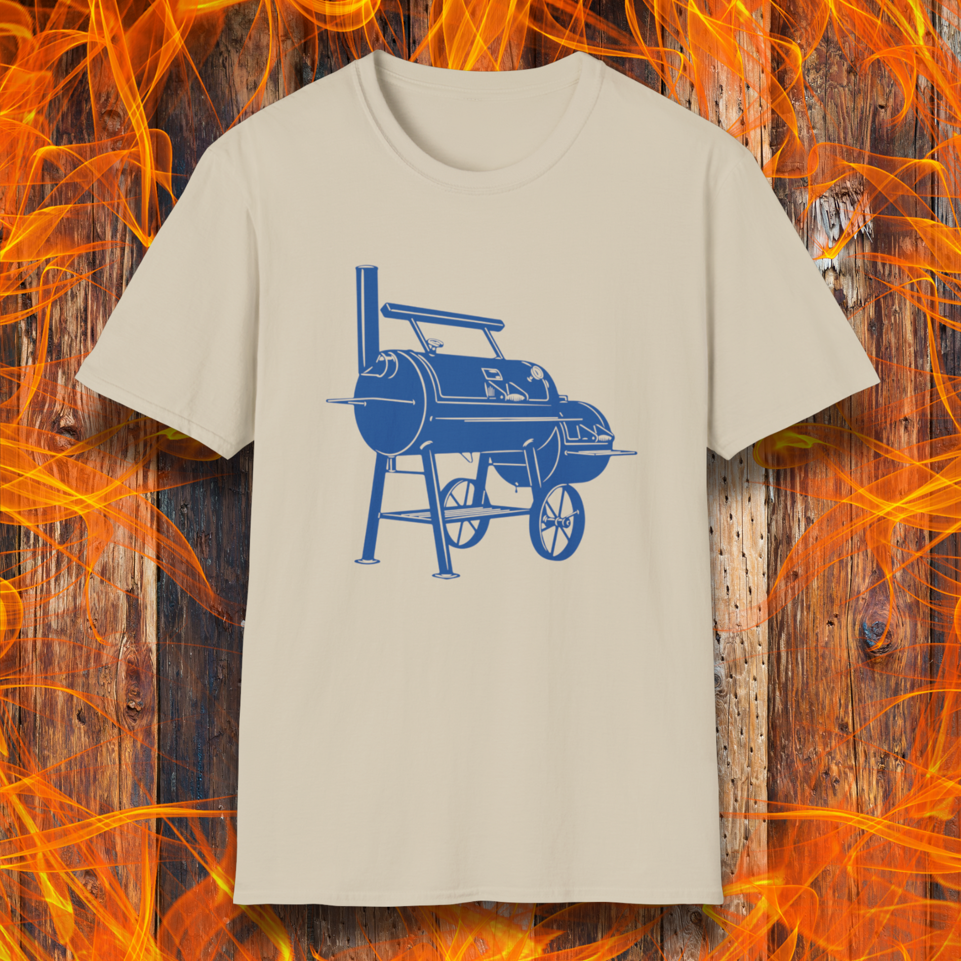 Beige t-shirt with blue barbecue graphic on a wooden background with flames