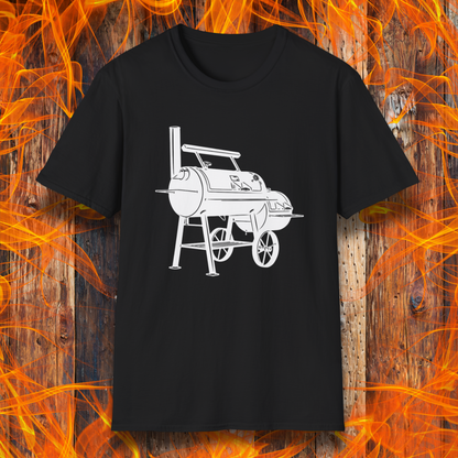 Black t-shirt with a white barbecue grill graphic on a wooden background with flames.