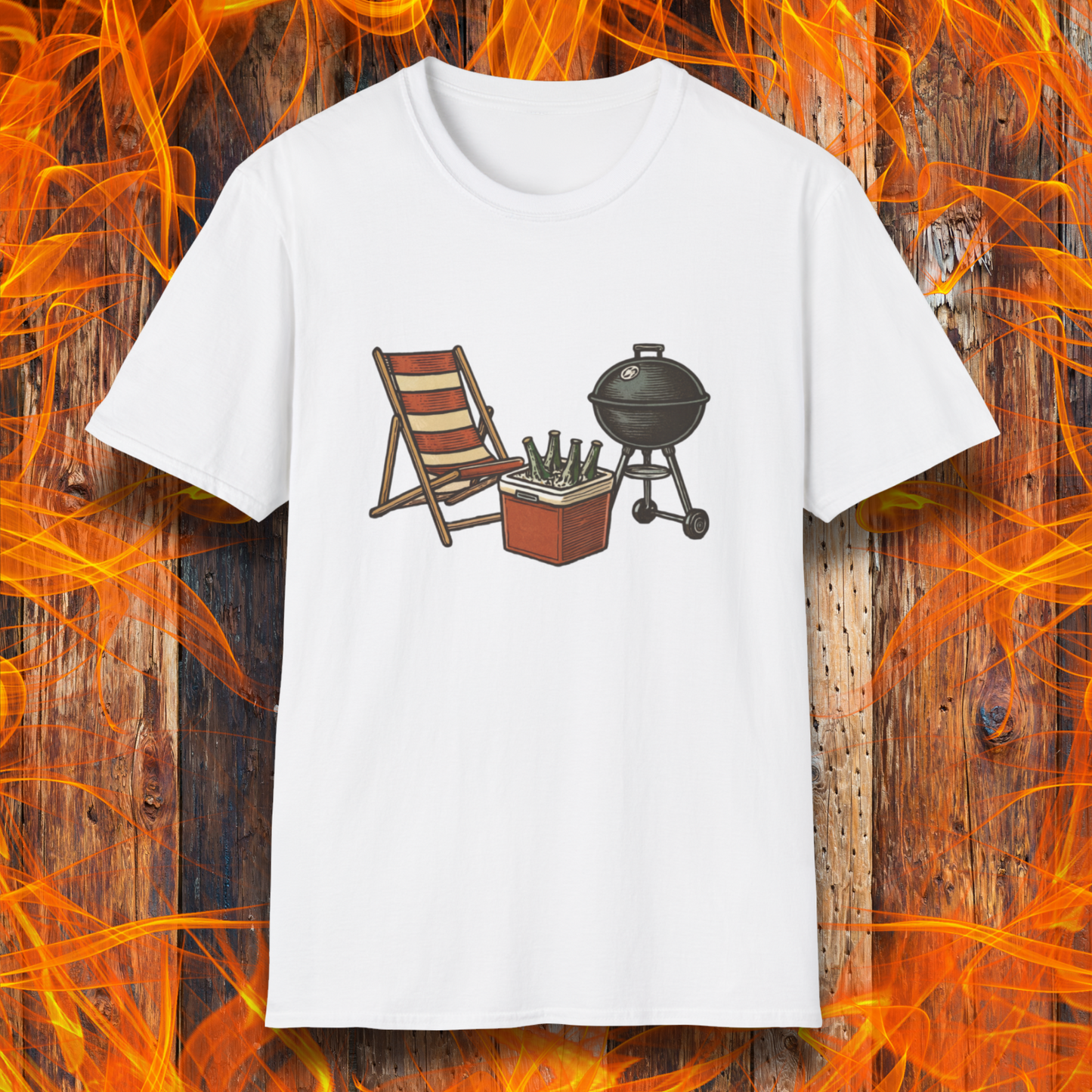 White t-shirt with a graphic of a grill, chair, and cooler on a wooden background with flames.