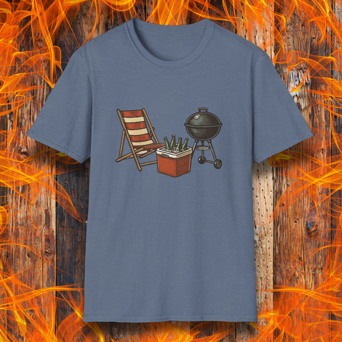 Blue t-shirt with a graphic of a grill, cooler, and chair on a wooden background with flames.