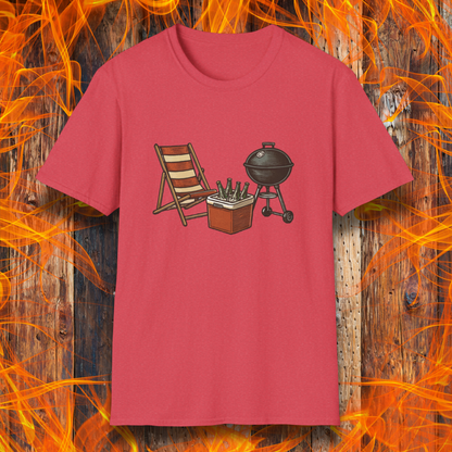 Red t-shirt with a graphic of a grill, chair, and cooler on a wooden background with flames.