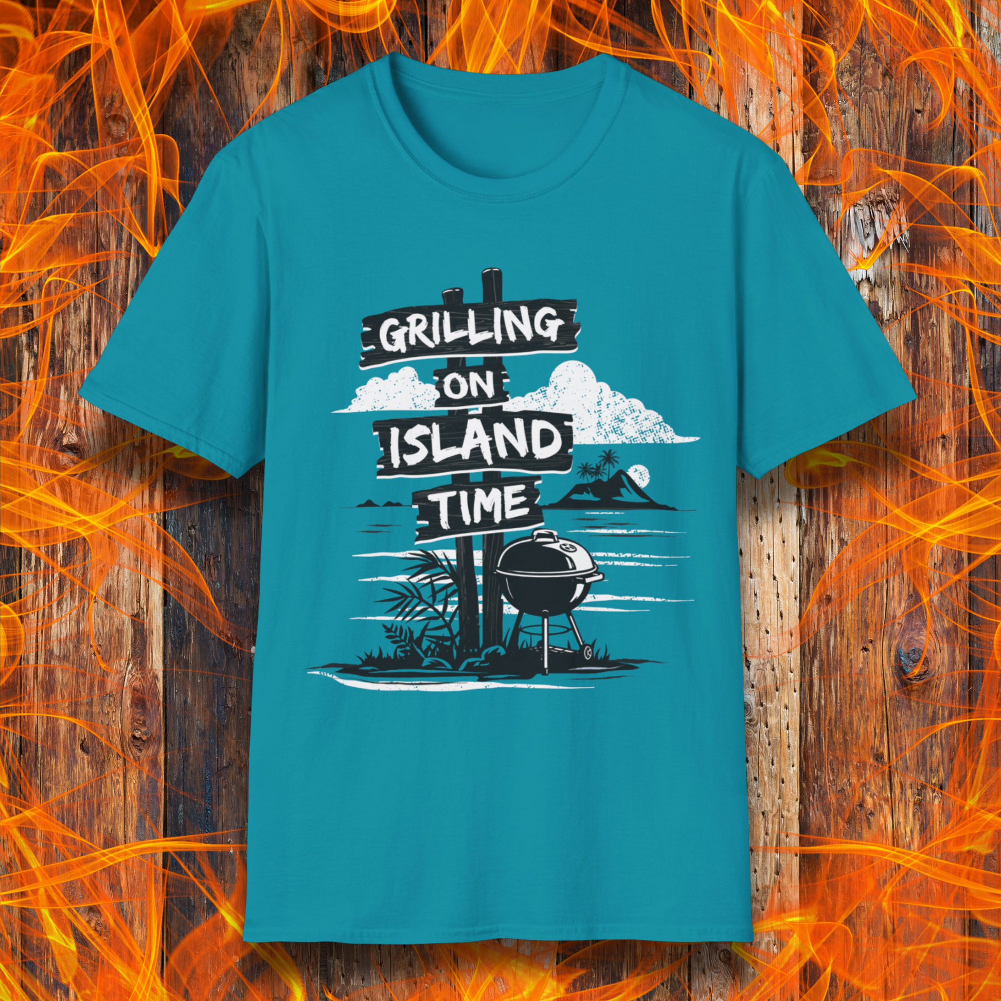 Blue t-shirt with 'Grilling on Island Time' graphic design on a wooden background with flames.