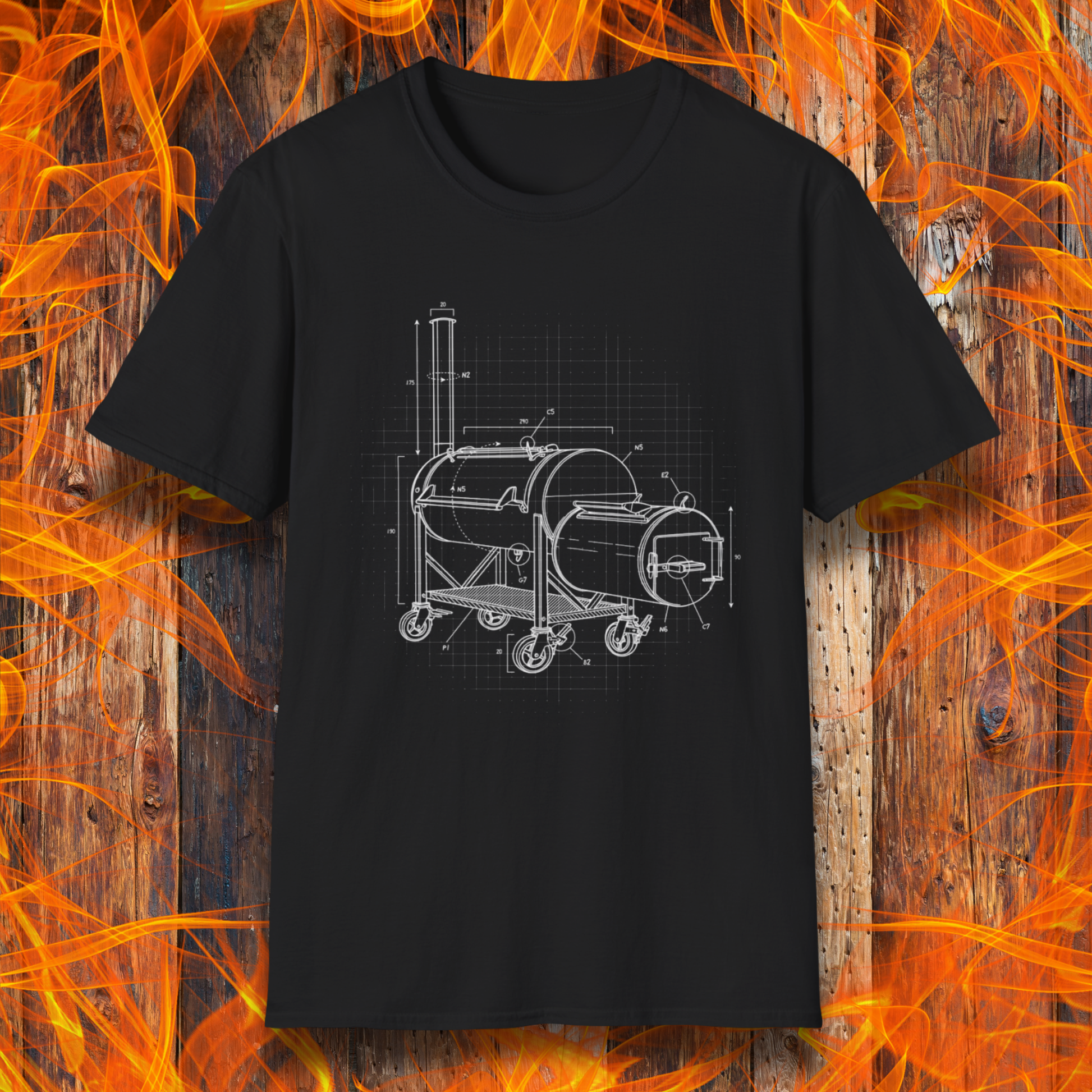 Black t-shirt with white barbecue grill design on a wooden background with flames.