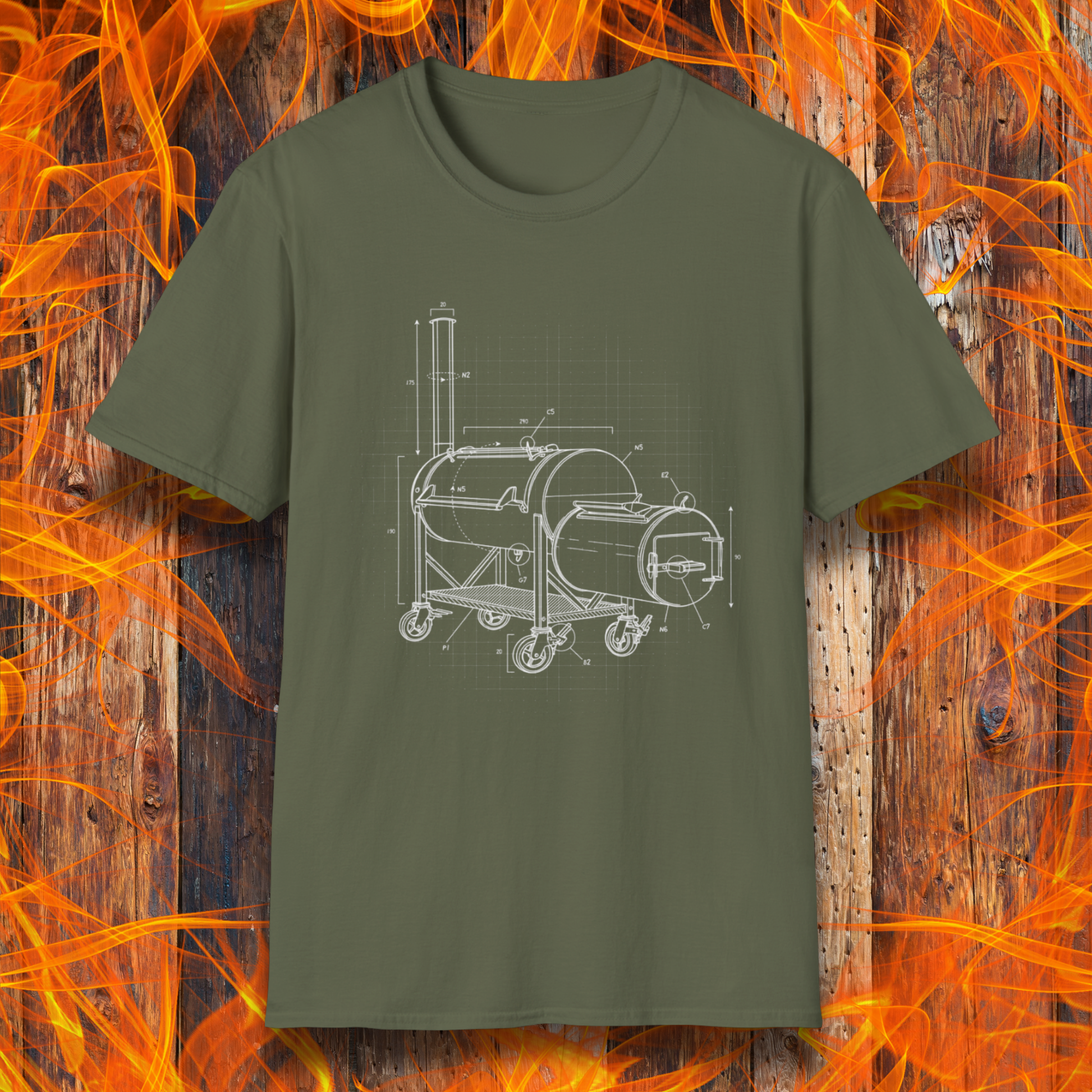 Green t-shirt with barbecue grill design on a wooden background with flames