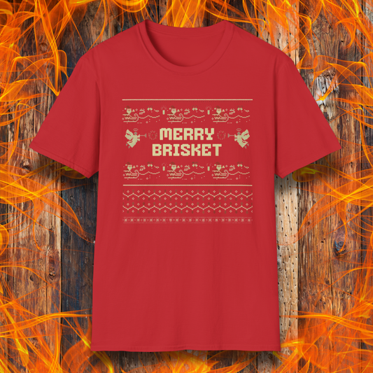 Red t-shirt with 'Merry Brisket' text on a wooden background with flames.