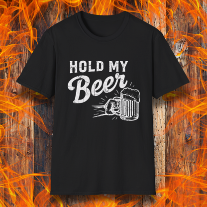 Black t-shirt with 'Hold My Beer' text and graphic on a wooden background with flames.