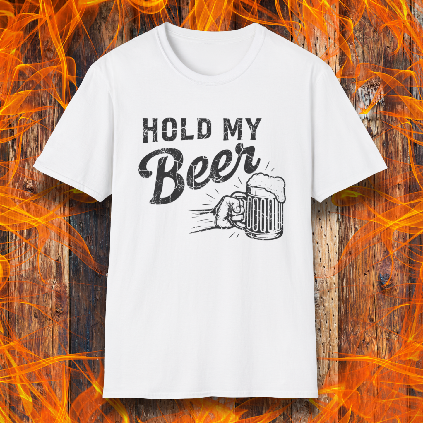 White t-shirt with 'Hold My Beer' graphic on a wooden background with flames.