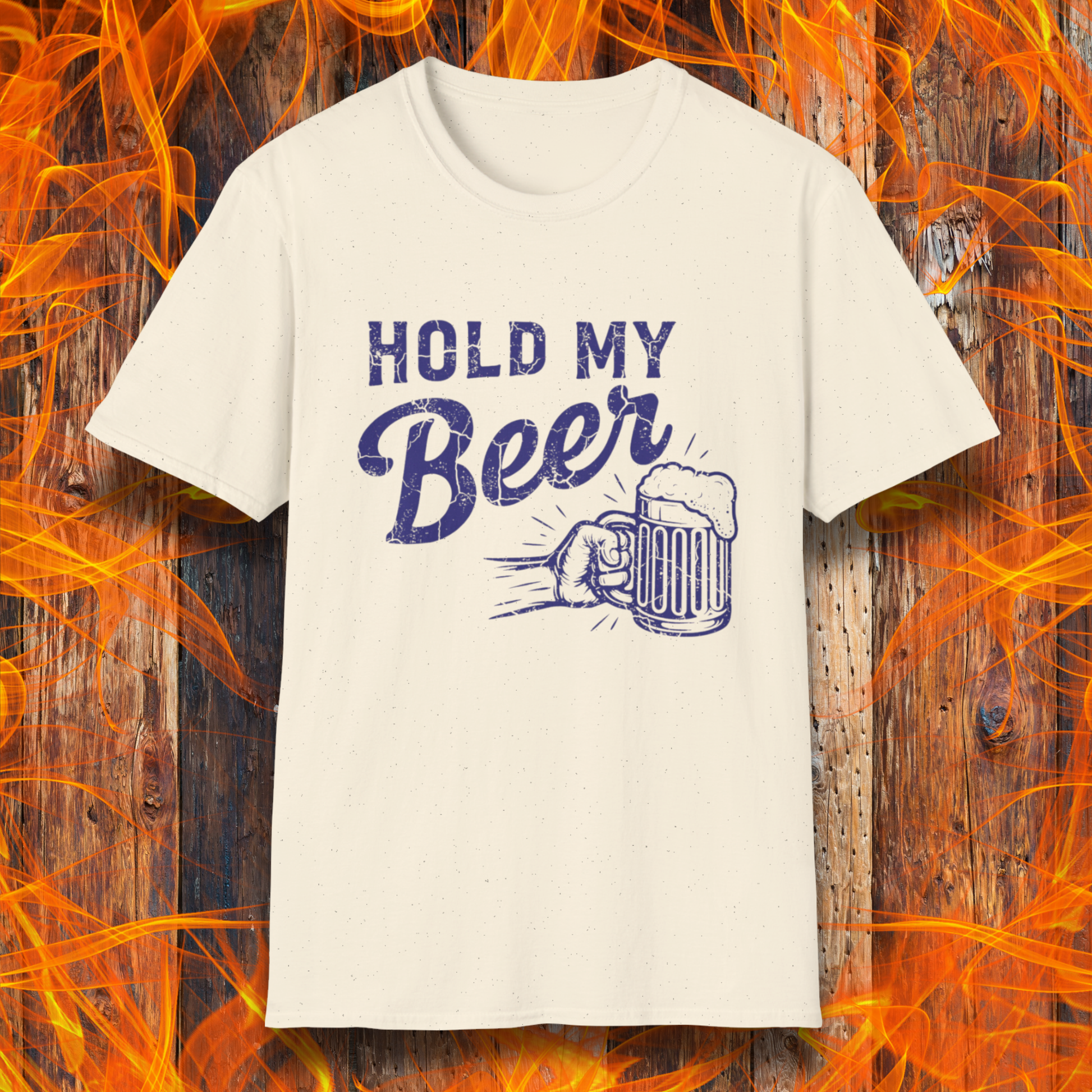 White t-shirt with 'Hold My Beer' design on a wooden background with flames.