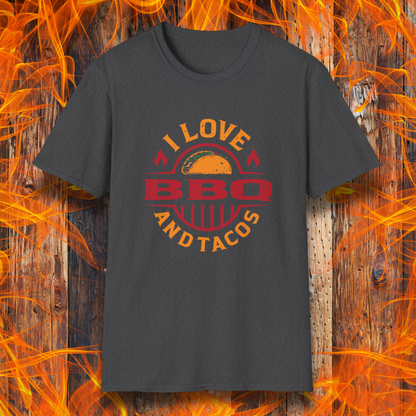 Gray t-shirt with 'I Love BBQ and Tacos' design on a wooden background with flames.