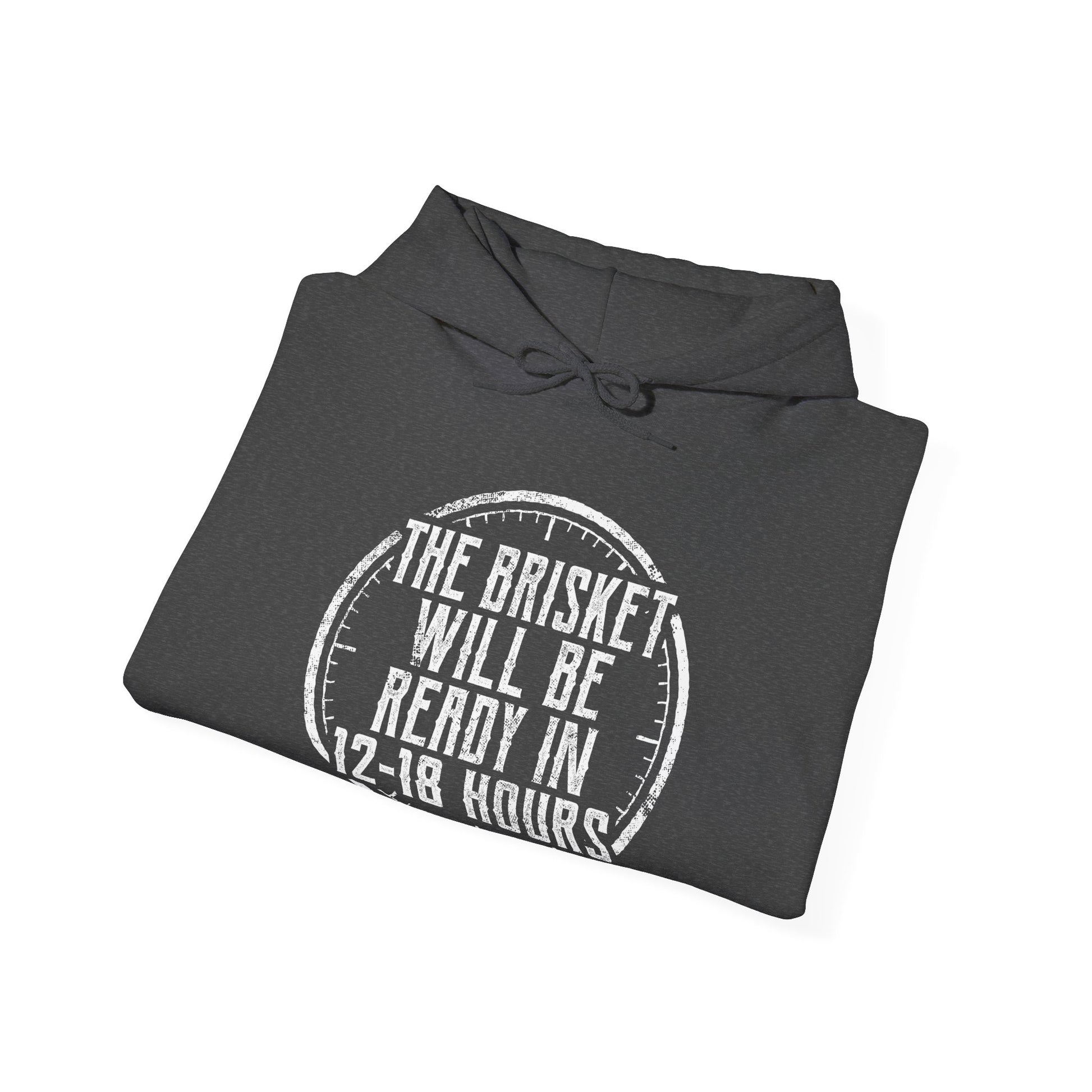 Folded gray hoodie with white text "The Brisket will be ready in 12-18 Hours" and a a click graphic on a white background