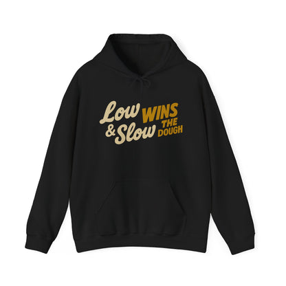 Black hoodie with yellow text 'Low Wins & Slow Dough' on a white background