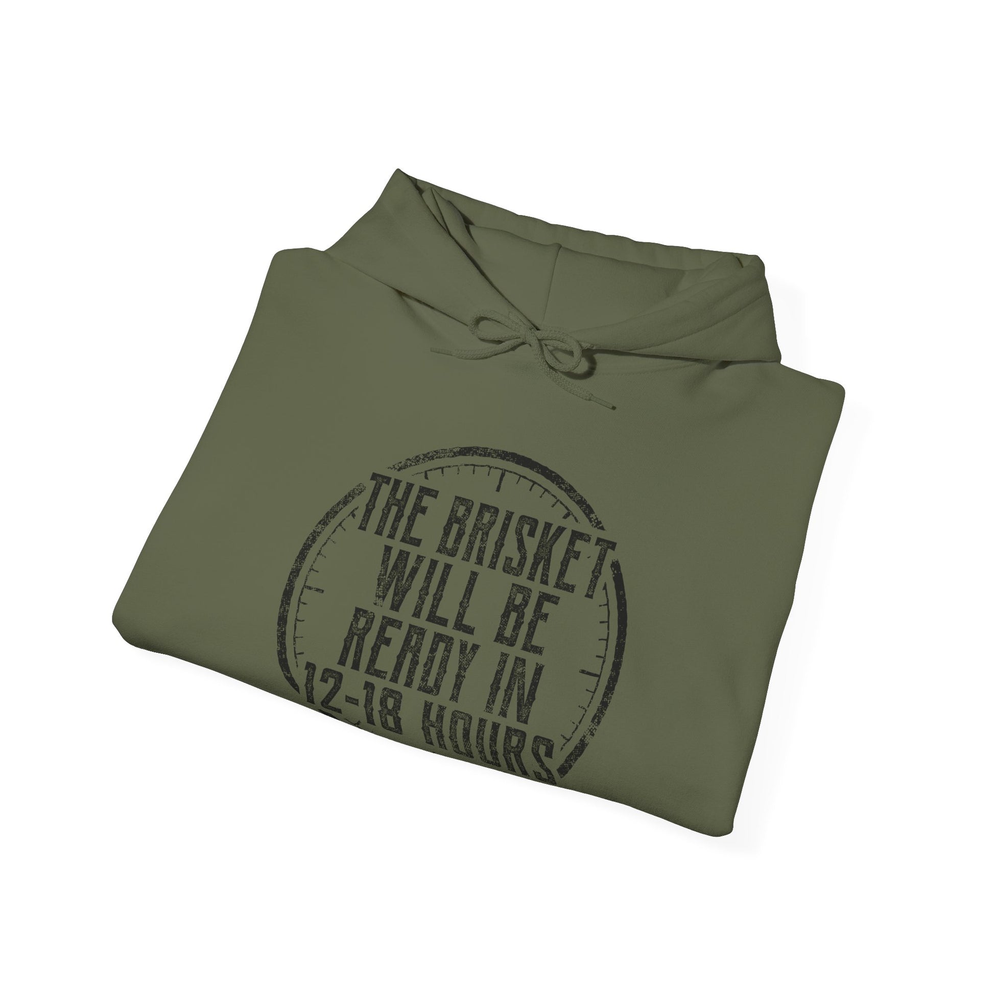 Folded green hoodie with white text "The Brisket will be ready in 12-18 Hours" and a a click graphic on a white background
