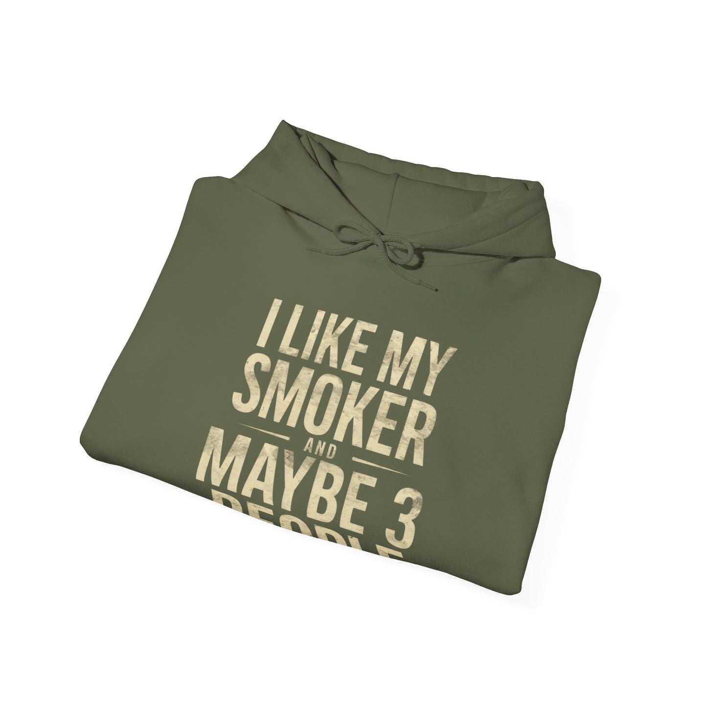 Folded green hoodie with gold text I Like My Smoker and Maybe 3 People” on a white background