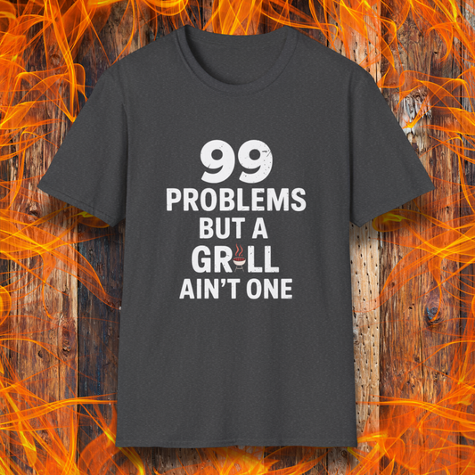 Dark Heather T-shirt with bold white text that says "99 Problems But a Grill Ain’t One," featuring a small red grill icon replacing the "I" in "Grill" — a playful shirt for BBQ fans and grilling pros.