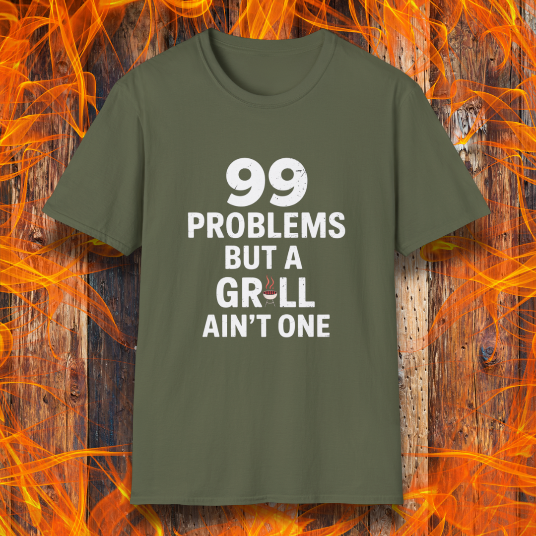 Military Green T-shirt with bold white text that says "99 Problems But a Grill Ain’t One," featuring a small red grill icon replacing the "I" in "Grill" — a playful shirt for BBQ fans and grilling pros.
