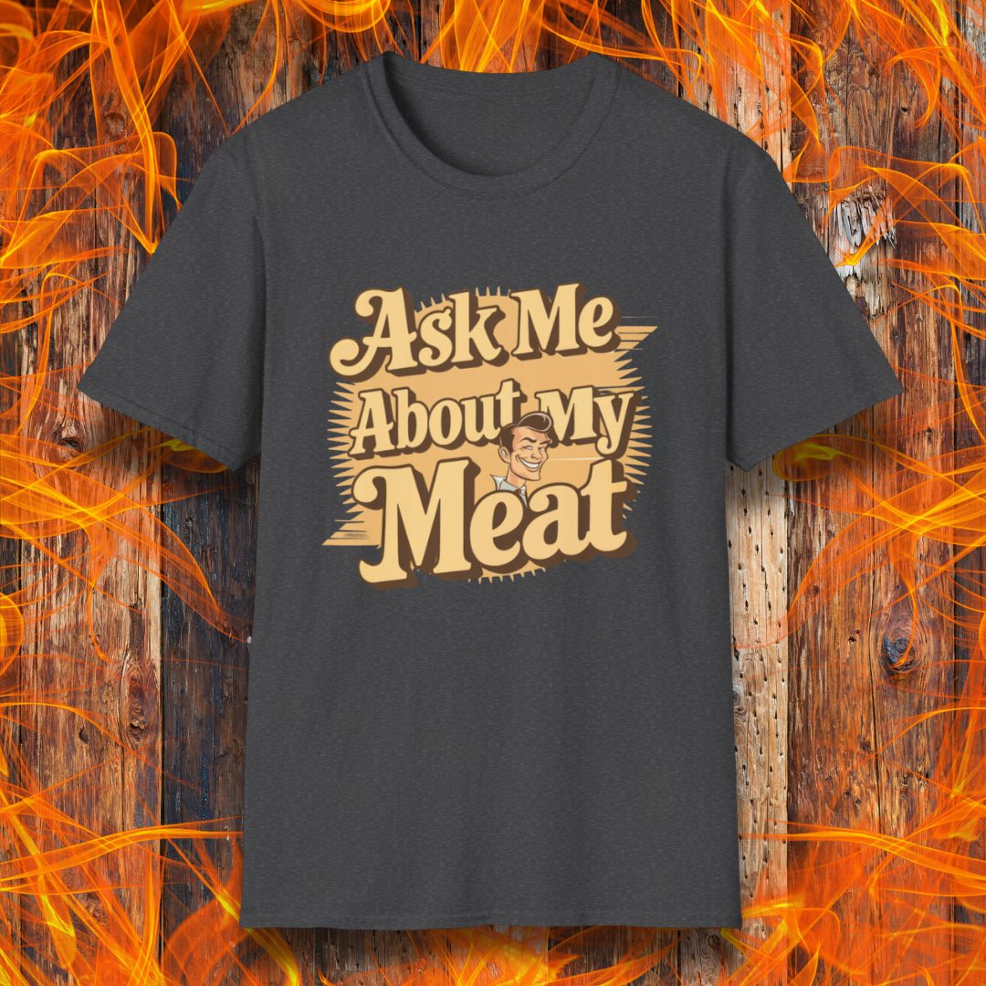 Dark Heather T-shirt featuring a retro-style design with the phrase 'Ask Me About My Meat' in bold, vintage lettering. The text is accented with a smiling, cartoon-style character, giving it a humorous and playful BBQ-themed vibe.
