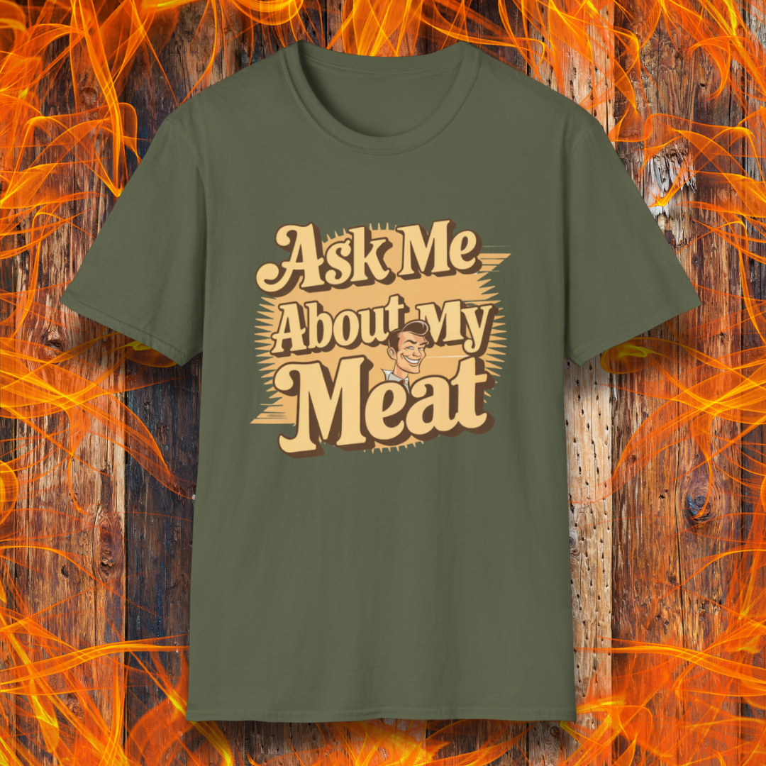 Military Green T-shirt featuring a retro-style design with the phrase 'Ask Me About My Meat' in bold, vintage lettering. The text is accented with a smiling, cartoon-style character, giving it a humorous and playful BBQ-themed vibe.
