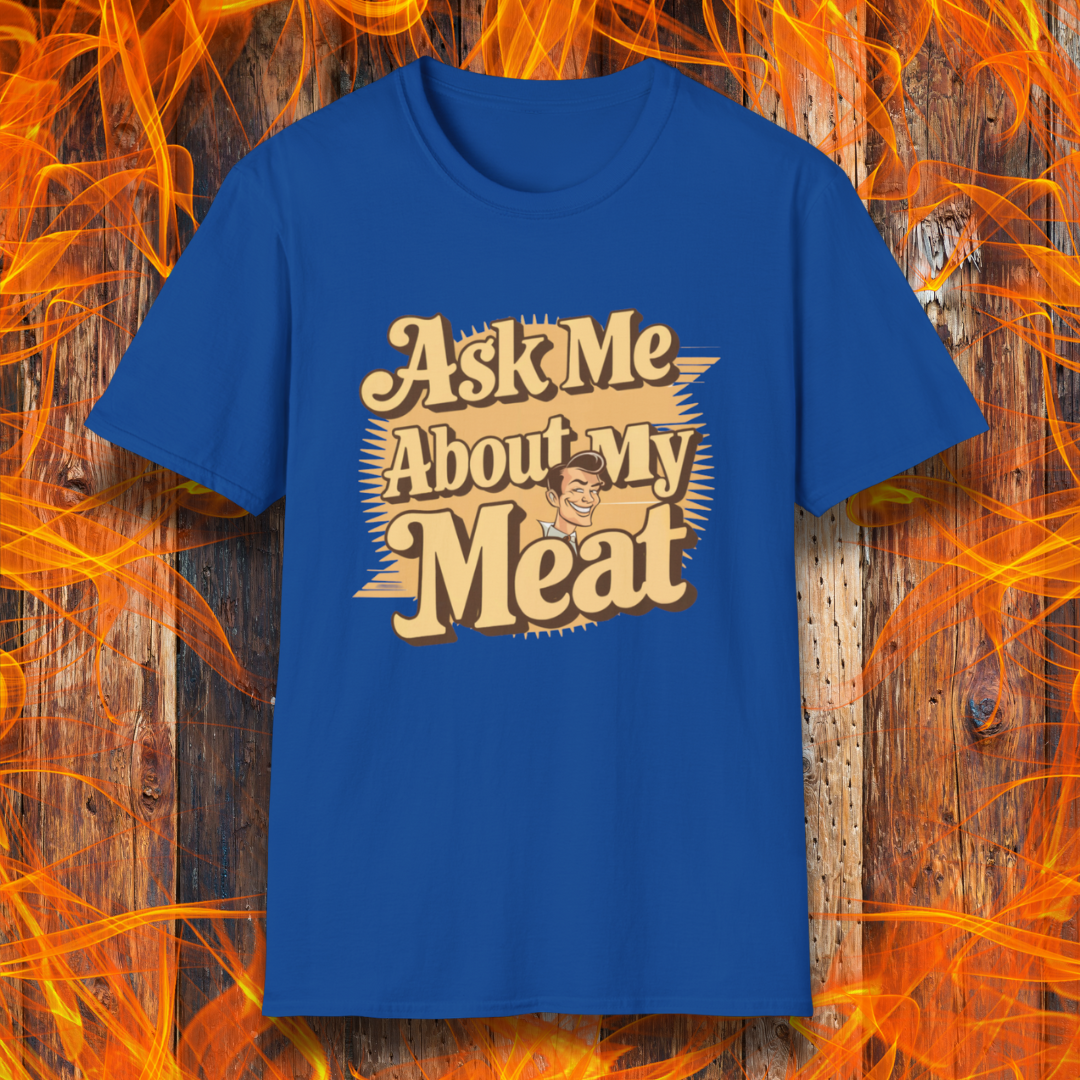 Royal Blue T-shirt featuring a retro-style design with the phrase 'Ask Me About My Meat' in bold, vintage lettering. The text is accented with a smiling, cartoon-style character, giving it a humorous and playful BBQ-themed vibe.