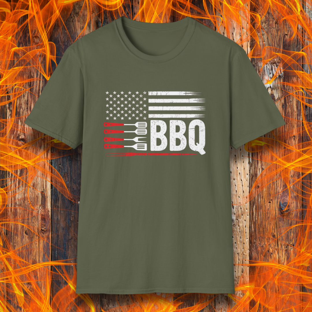 Green t-shirt with American flag and BBQ text on a wooden background with flames.