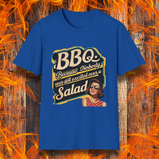 Royal Blue t-shirt featuring a retro-style design with the phrase 'BBQ. Because Nobody Ever Got Excited Over a Salad,' alongside a vintage pin-up style woman in sunglasses and a red polka dot dress."