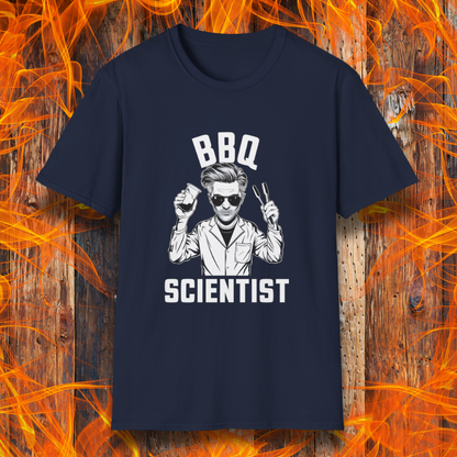 Navy t-shirt featuring a bold black-and-white illustration of a cool scientist holding BBQ tongs and a beaker, with the phrase 'BBQ Scientist' displayed above and below."
