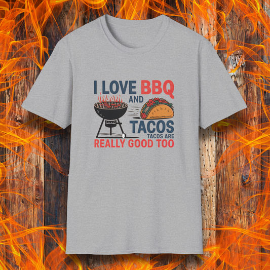 Sport Grey T-shirt features a fun and bold design that reads, "I Love BBQ and Tacos... Tacos Are Really Good Too," with graphics of a flaming grill and a delicious taco. Perfect for BBQ lovers who also enjoy a good taco, this shirt combines humor and food passion in a stylish way.