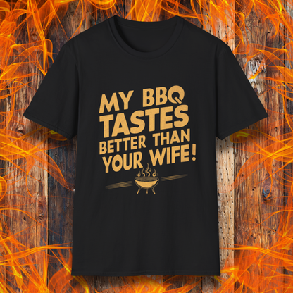 Black T-shirt with a bold, cheeky design that reads 'MY BBQ TASTES BETTER THAN YOUR WIFE!' in vintage-style typography, featuring a small flaming grill icon. Perfect for grill masters with a sense of humor.